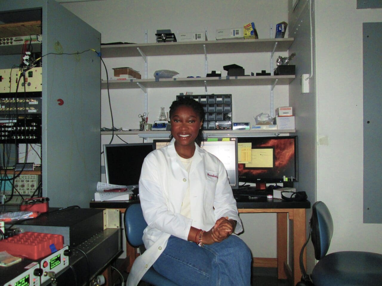 Adja Camara smiling in the Assad Lab at Harvard Medical School.